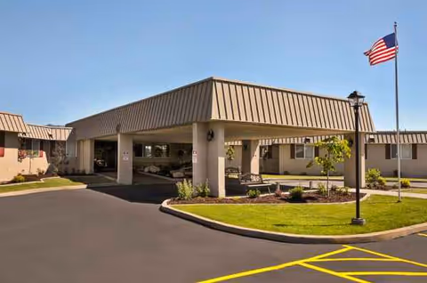 Exterior view of Life Care Center of Idaho Falls with a covered entrance and flagpole.