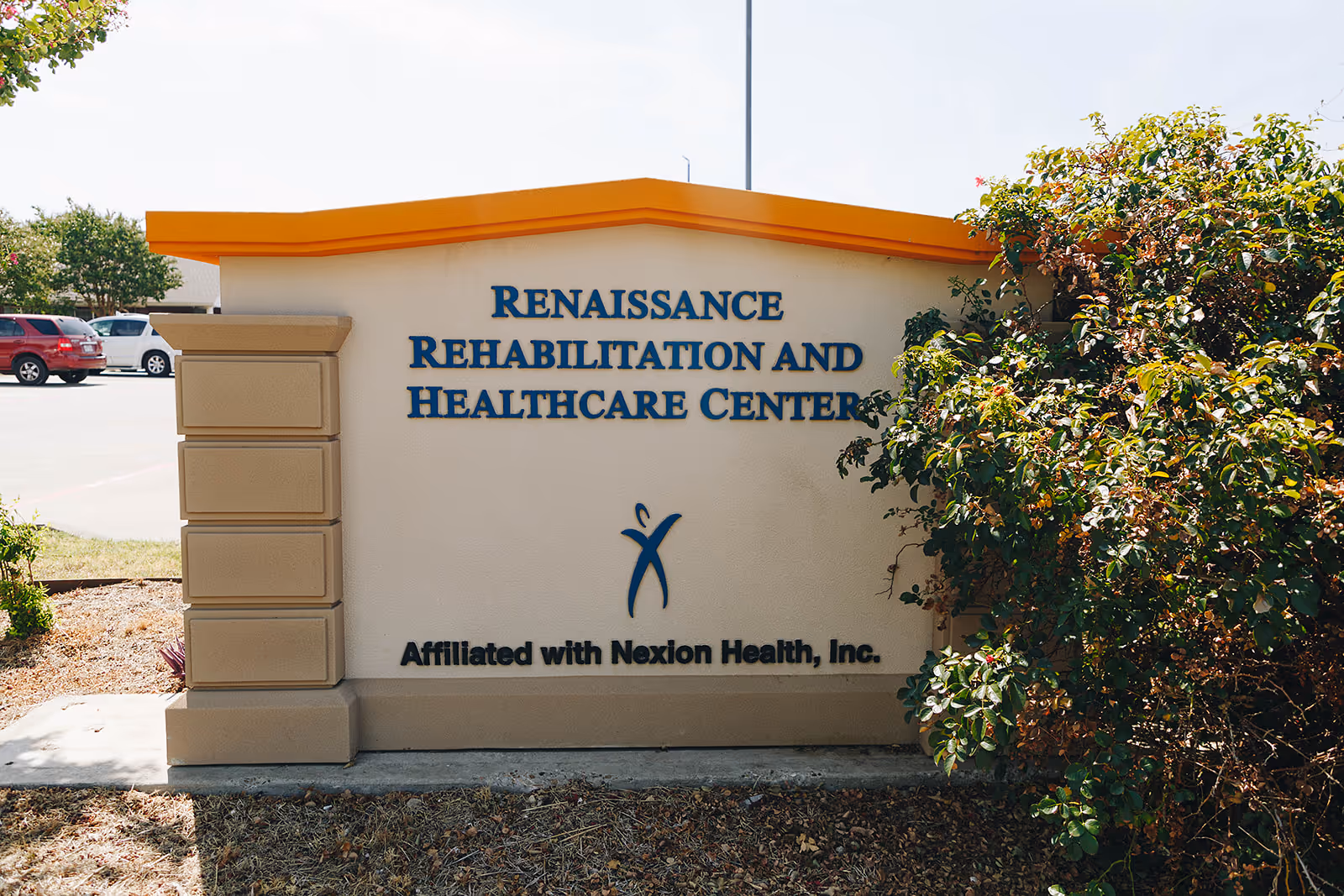 Exterior sign for Renaissance Rehabilitation and Healthcare Center with landscaping on the right.