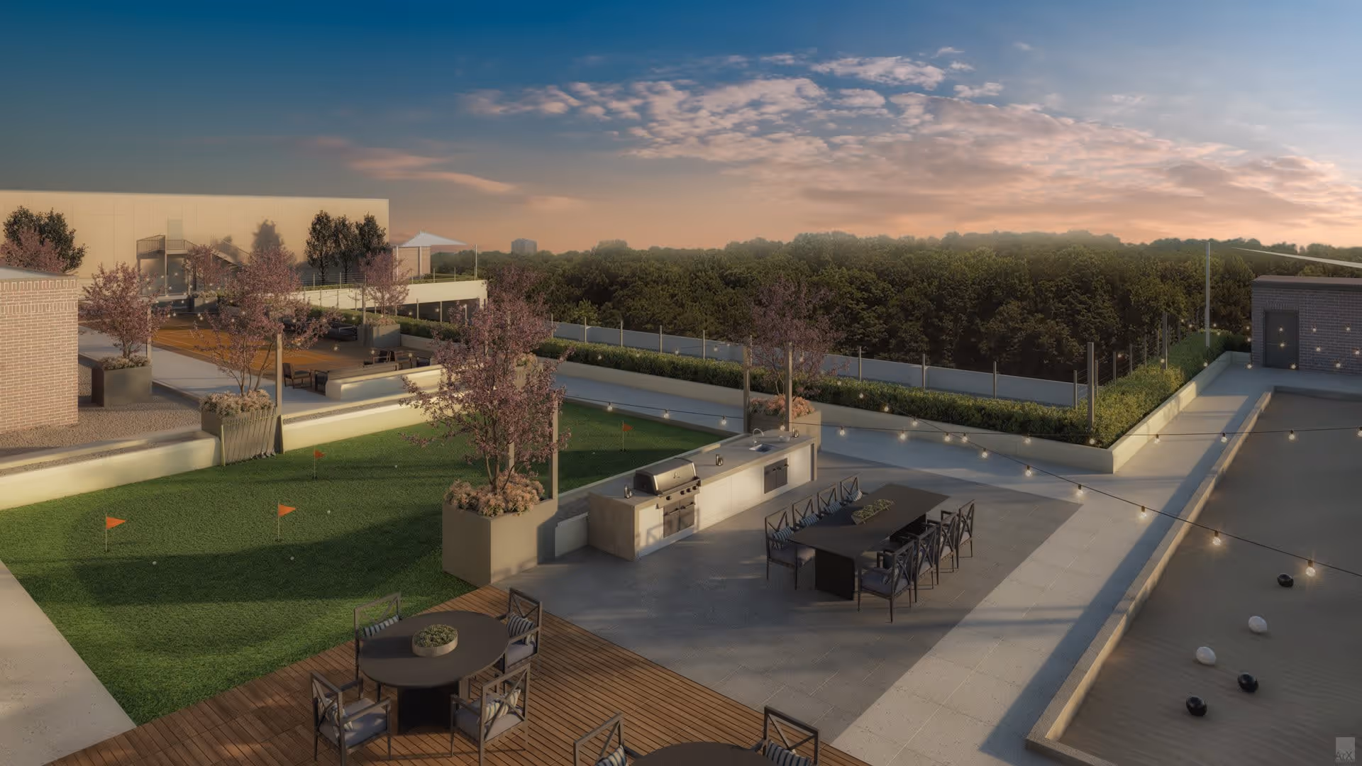 Outdoor patio area at Attiva Peachtree featuring a putting green with small red flags, several round and rectangular tables with chairs, an outdoor kitchen with a grill and sink, string lights overhead, and a bocce ball court. The area is surrounded by planters with trees and overlooks a wooded landscape under a partly cloudy sky at sunset.