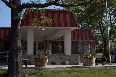 Front view of Maple Ridge Health Services facility with stone facade and planters