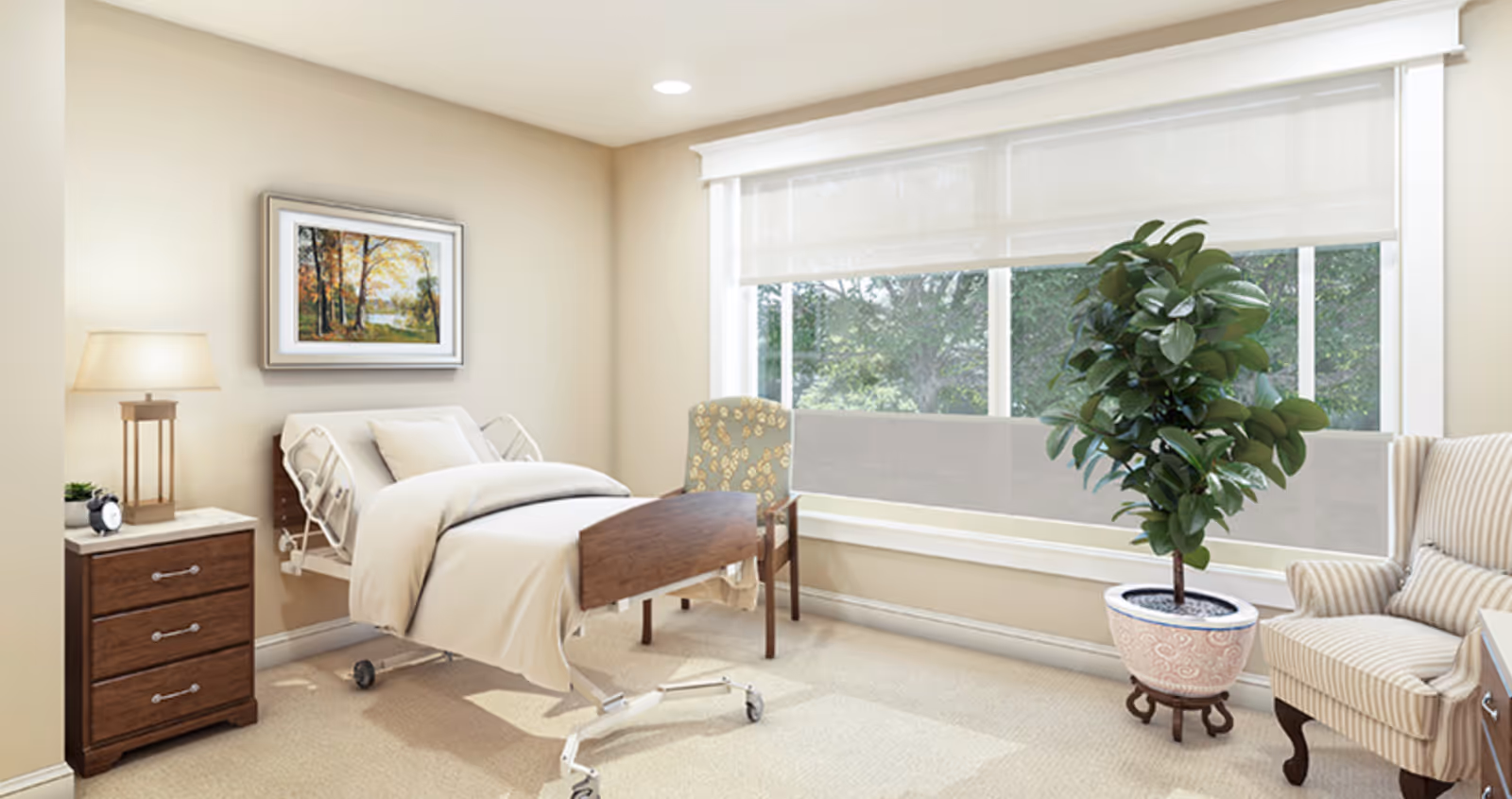 A bright and cozy bedroom in a senior living facility featuring a hospital-style bed with white bedding, a wooden nightstand with a lamp and alarm clock, a patterned armchair, a large potted plant, and a large window with white blinds letting in natural light. A framed painting of a forest scene hangs on the beige wall.