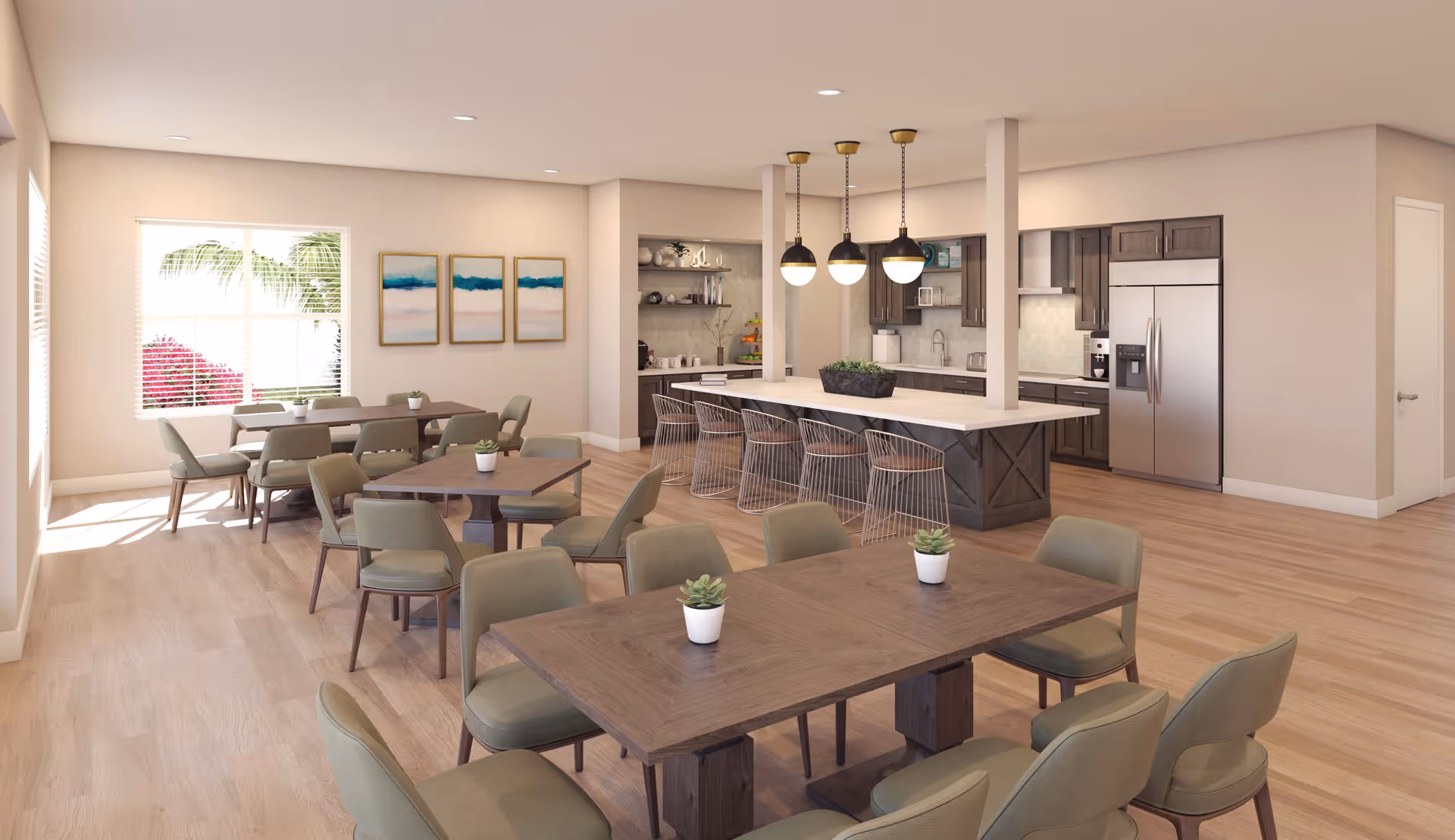 A spacious, modern dining area with multiple wooden tables and green cushioned chairs. Small potted plants are placed on each table. The room features large windows letting in natural light, three pendant lights hanging over a kitchen island with bar stools, and a kitchen area with dark wood cabinets and stainless steel appliances in the background.