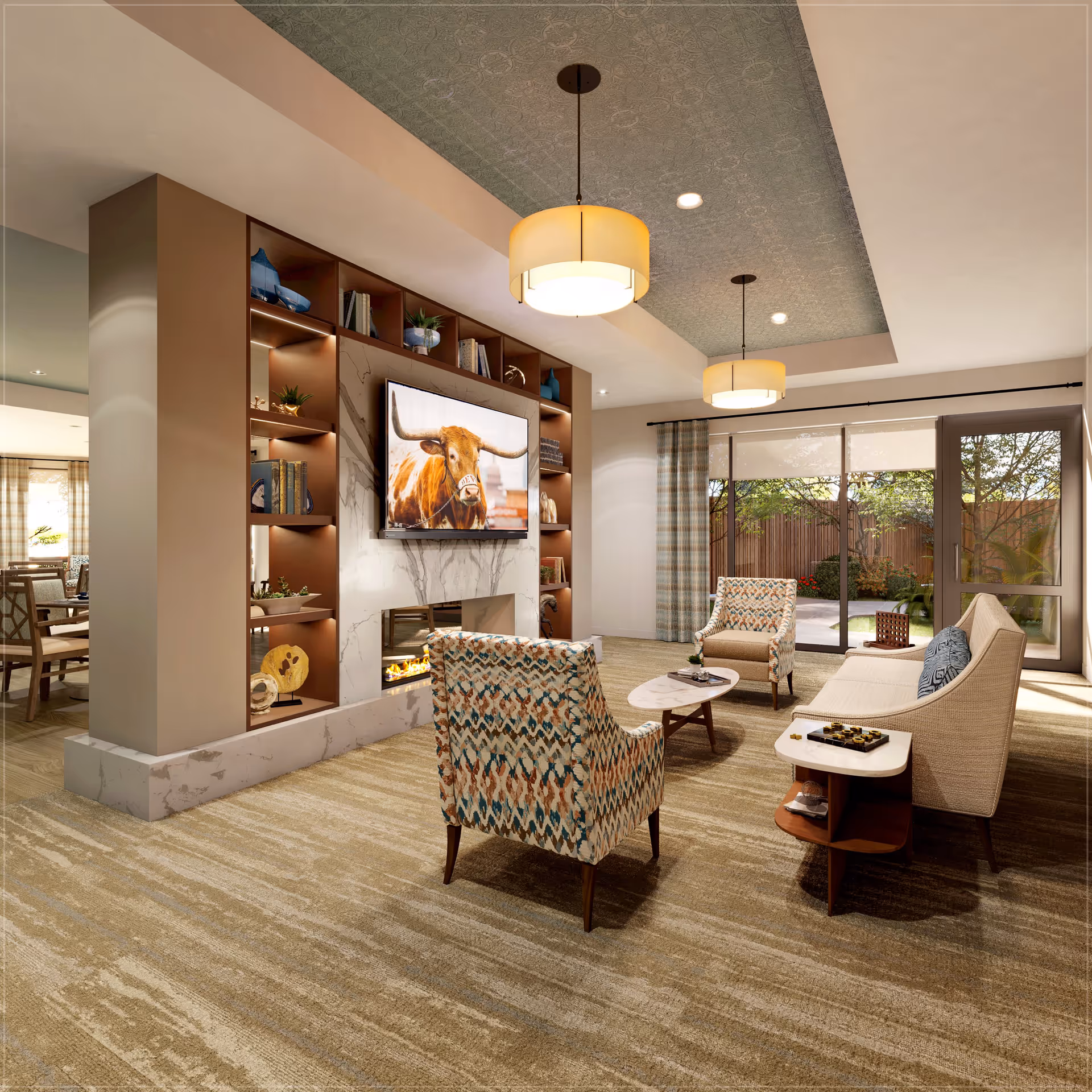 A cozy living room with patterned armchairs, a beige sofa, a marble coffee table, and a side table with a chess set. The room features a built-in fireplace beneath a mounted TV displaying an image of a longhorn steer. Large windows with curtains provide a view of a garden outside. The ceiling has decorative panels and two hanging light fixtures.