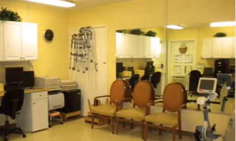 Common interior area in Chadwick Nursing and Rehab Center with desks, chairs, and exercise equipment.