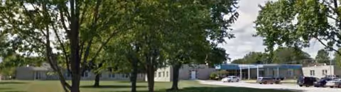 Exterior view of Algoma Medical Center with trees and a parking lot.