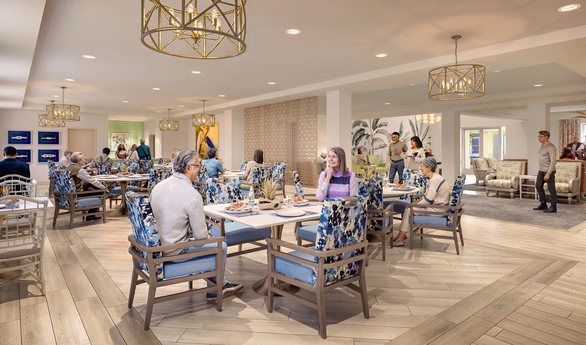 Bright communal dining area with seniors seated at tables and patterned chairs under pendant lighting.