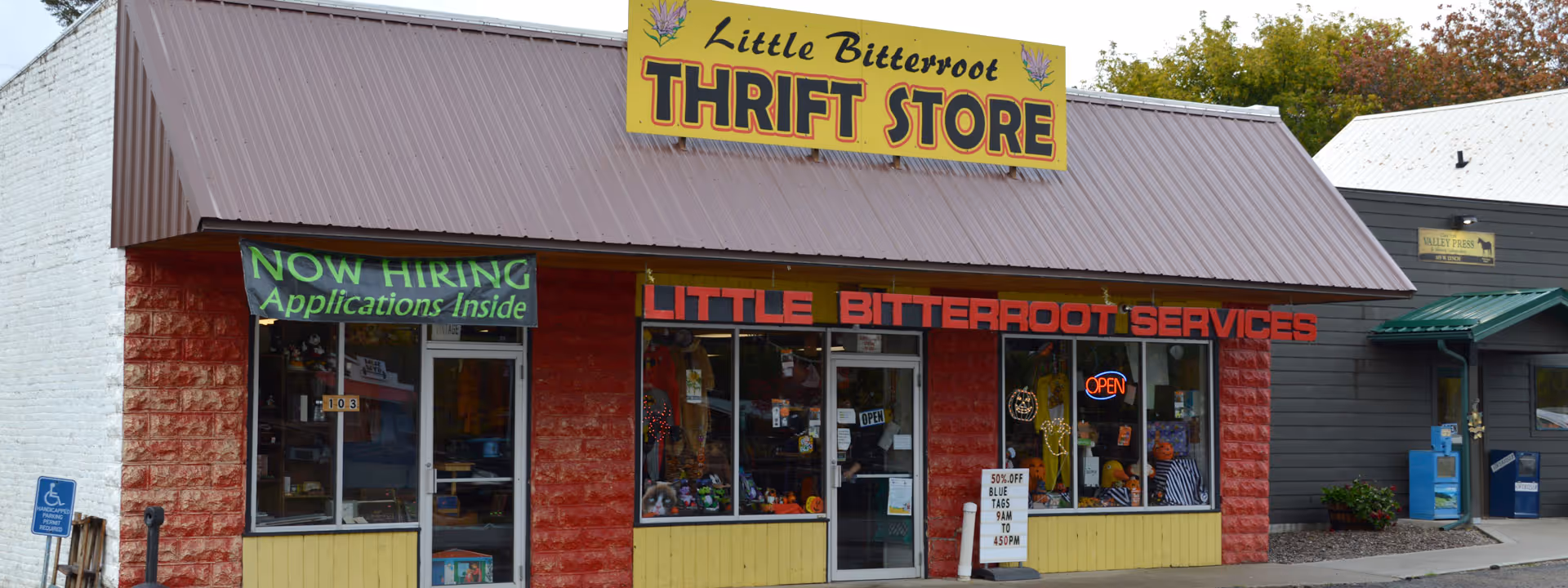 Front view of a thrift store storefront with Little Bitterroot Services signage.