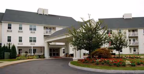 Exterior view of Holiday Lodge at Cold Spring with a covered entrance and landscaped driveway