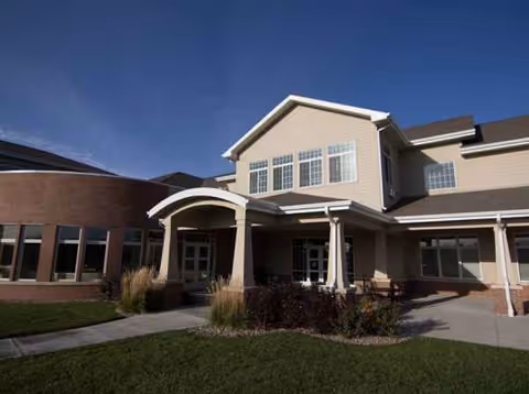 Exterior view of Ridgewood Senior Living facility entrance with landscaped path