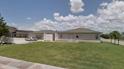Single-story Windchime at the Village Assisted Living exterior with front lawn and driveway.