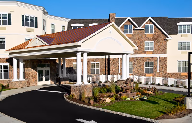 Exterior view of The Bristal Assisted Living at Woodcliff Lake with a covered entrance.