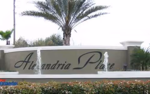 Entrance sign reading Alexandria Place with two water fountains and landscaping.