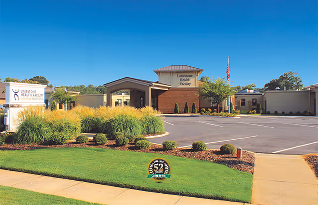 Front exterior of Limestone Health Facility with drive-up entrance, lawn and signage.