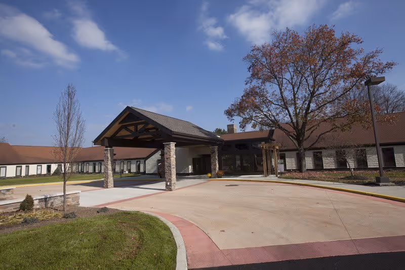 Riverview facility entrance with porte-cochère and curved driveway.