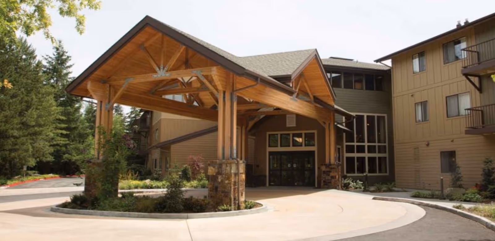 Wooden entrance canopy over the Bellewood senior residence exterior.