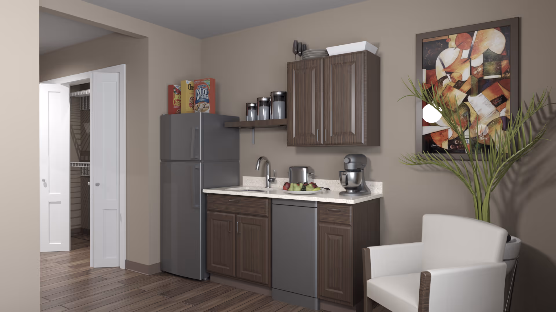 Small kitchenette with refrigerator, sink, cabinets, countertop appliances, a white armchair, potted plant and wall art.