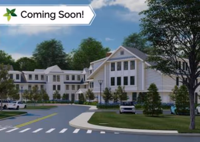 Exterior view of a modern senior living facility front with a Coming Soon banner