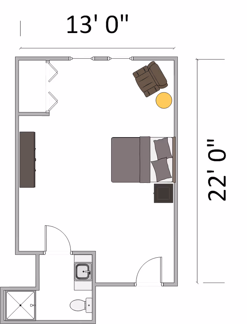 Floor plan of a room measuring 13 feet by 22 feet, featuring a bed with two pillows, a nightstand, a recliner chair with a small round table, a dresser, and an attached bathroom with a shower, toilet, and sink.