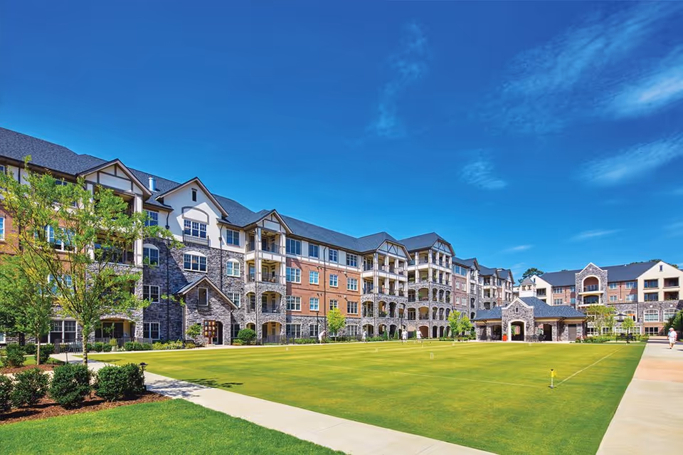 Exterior view of The Terraces at Peachtree Hills Place with a manicured courtyard lawn.
