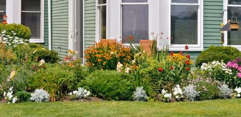 Front view of Piper Shores building with a colorful garden in the foreground.