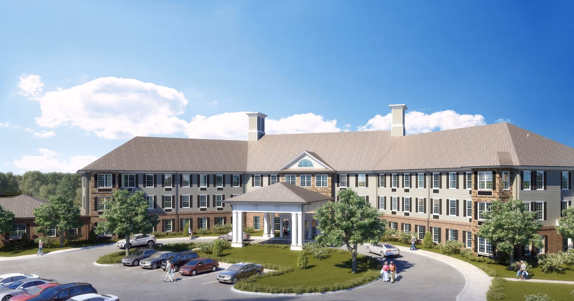 Front exterior view of a large, three-story senior living facility building with a covered entrance, surrounded by trees and a parking lot with several cars. People are walking near the entrance and around the parking area under a blue sky with some clouds.