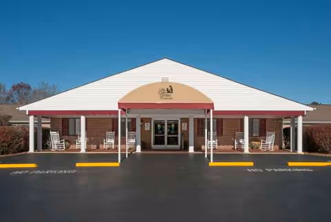 Front view of Life Care Center of Crossville entrance with rocking chairs.