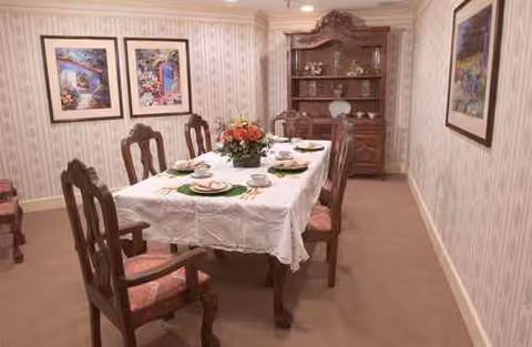 Regent Care Center dining room set for a formal meal with china.