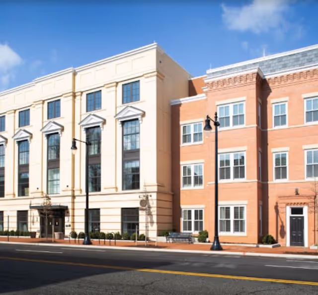 Exterior view of a multi-story senior living building along a city street.