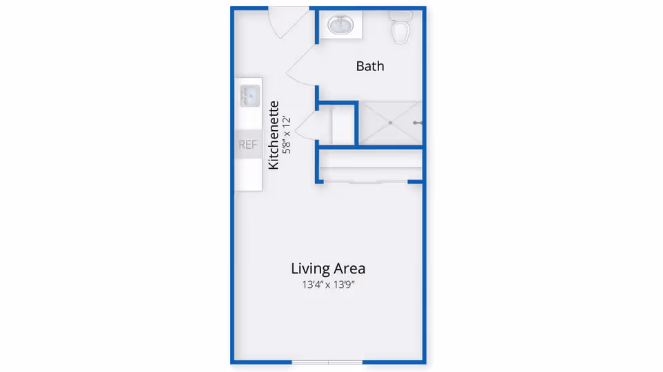 Floor plan of a small living space at The Village at Brookfield Common, showing a living area measuring 13 feet 4 inches by 13 feet 9 inches, a kitchenette measuring 5 feet 8 inches by 12 feet, and a bathroom with a sink, toilet, and shower.