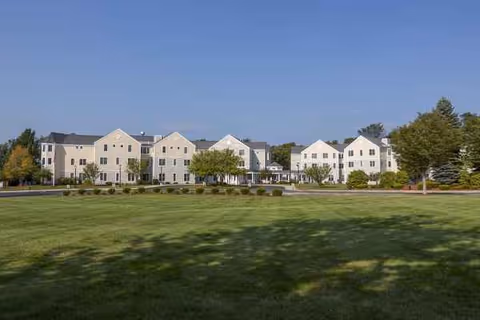 Exterior view of Benchmark at North Andover with a multi-building campus and green lawn.
