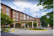 Exterior view of Edinburgh Square senior living building with covered entrance.