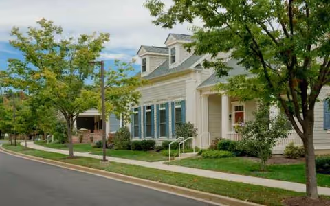 Exterior view of Wilson Health Care Center with walkway and trees.