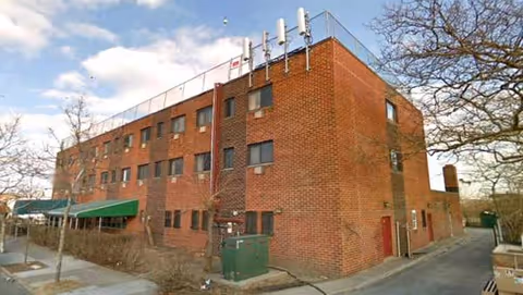 Exterior brick building of Seaview Manor Home for Adults with a green awning.