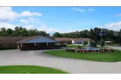 Single-story care facility with a covered entrance, circular driveway and central fountain set in a grassy, tree-lined landscape.