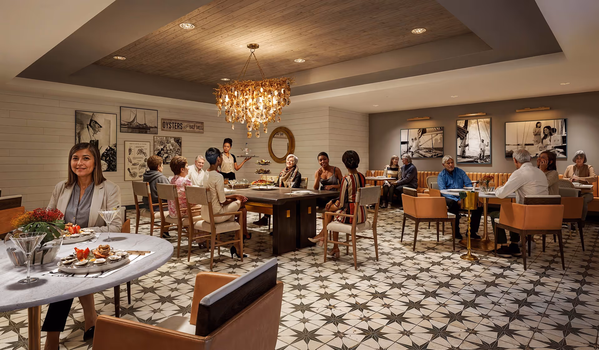 Residents and staff socialize in an elegant dining room with patterned tile floor, round and rectangular tables, and a central chandelier.
