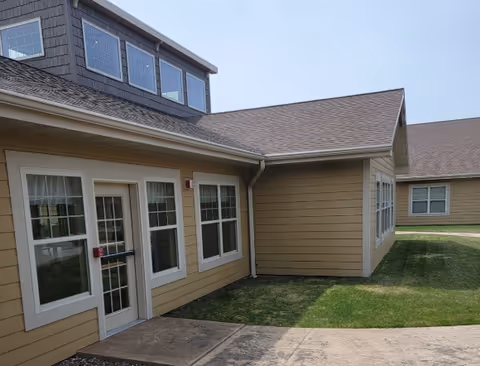Exterior view of Bayview Senior Care building with beige siding, windows, and entry door.