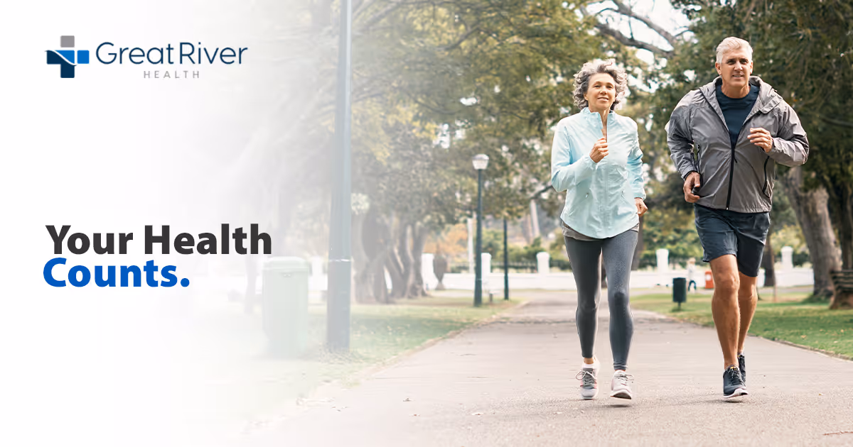 Two older adults jogging on a tree-lined park path beside promotional text that reads 'Your Health Counts.'