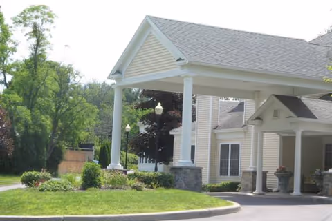 Hillcrest Spring Residential front entrance with columns, a covered porch, and landscaped lawn.