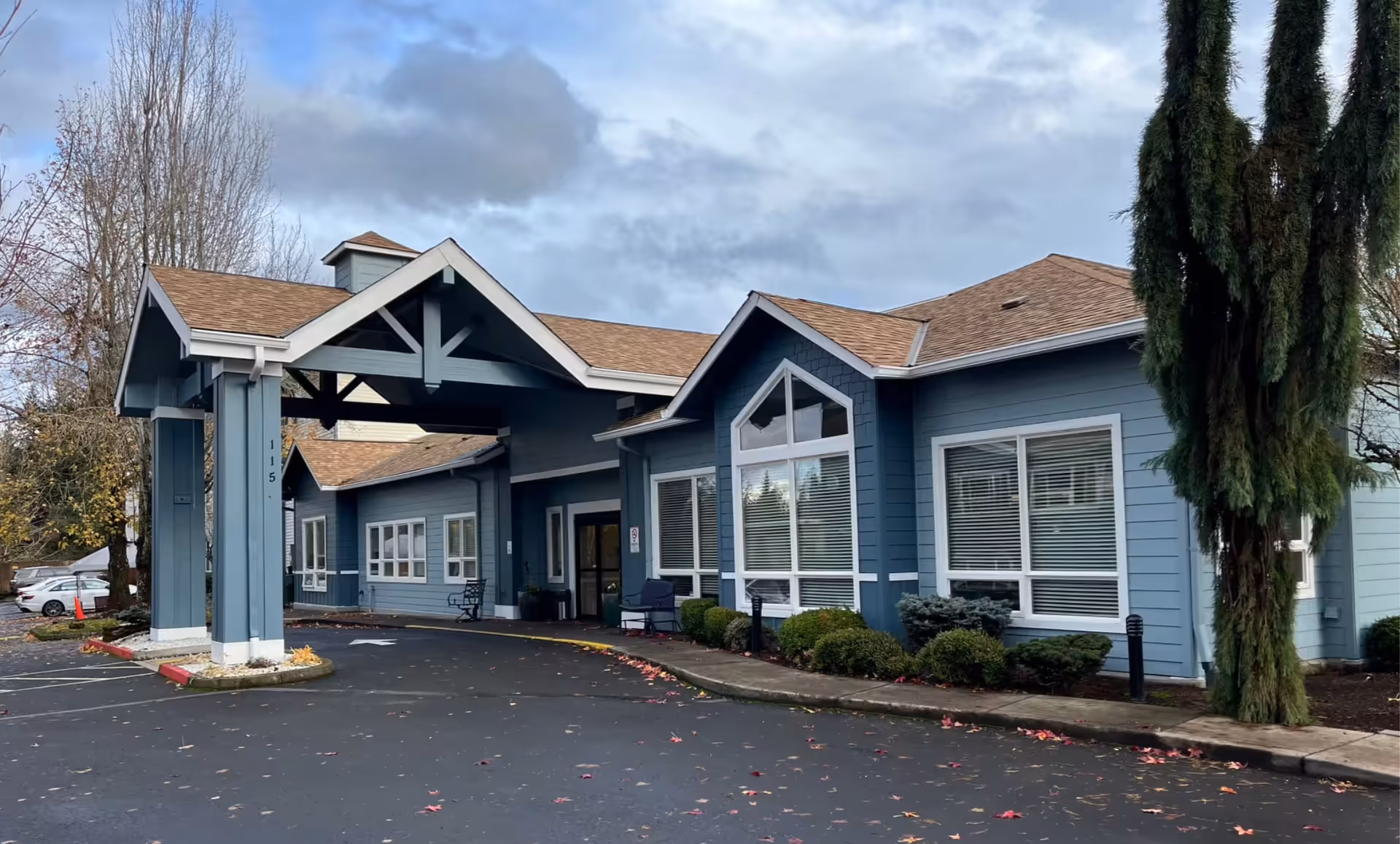 Blue Atrium at Mc Loughlin Place facility with a covered entrance and large front windows