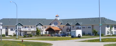 Front exterior view of Poplar Meadows Senior Living, a low-rise building with a green roof.