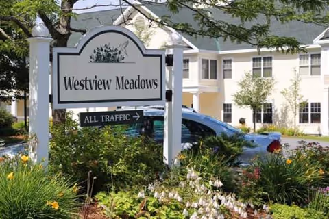Westview Meadows sign in front of a residential building with landscaping.