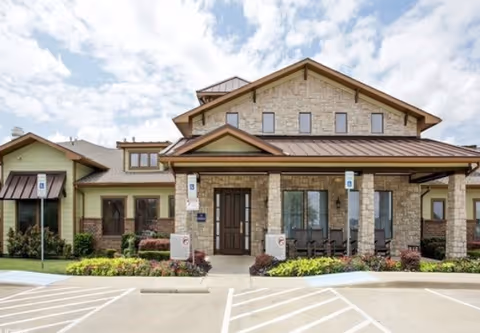 Front view of Buffalo Creek Assisted Living building with stone facade and entrance.