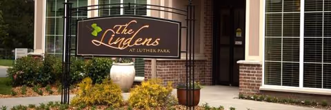 The Lindens at Luther Park entrance sign with brick facade and landscaping.