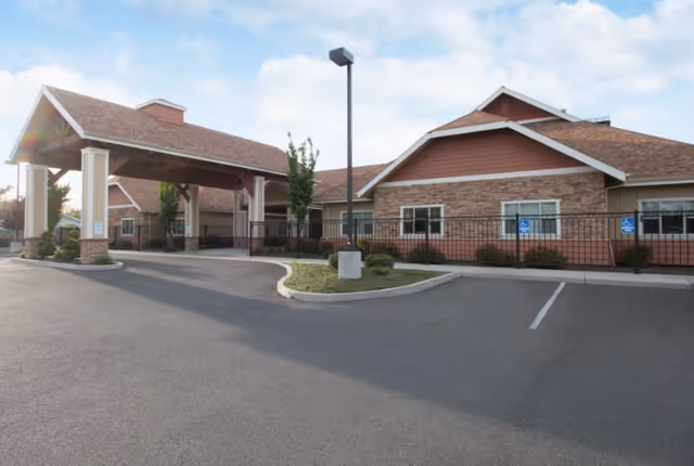 Exterior view of Table Rock Memory Care Community with covered entrance and parking.