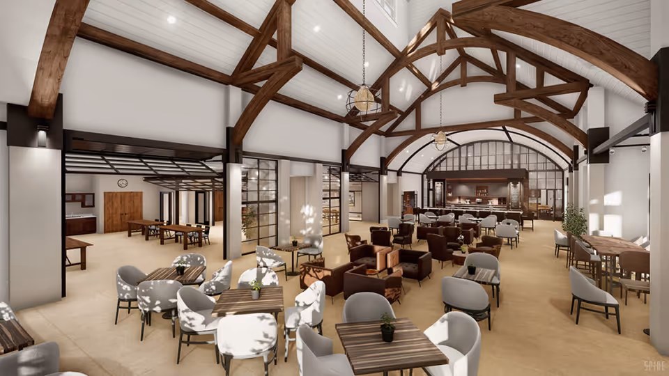 Spacious senior living common area with high vaulted ceilings featuring exposed wooden beams, multiple seating arrangements including tables with chairs and comfortable armchairs, large windows allowing natural light, and a bar or service counter at the far end.