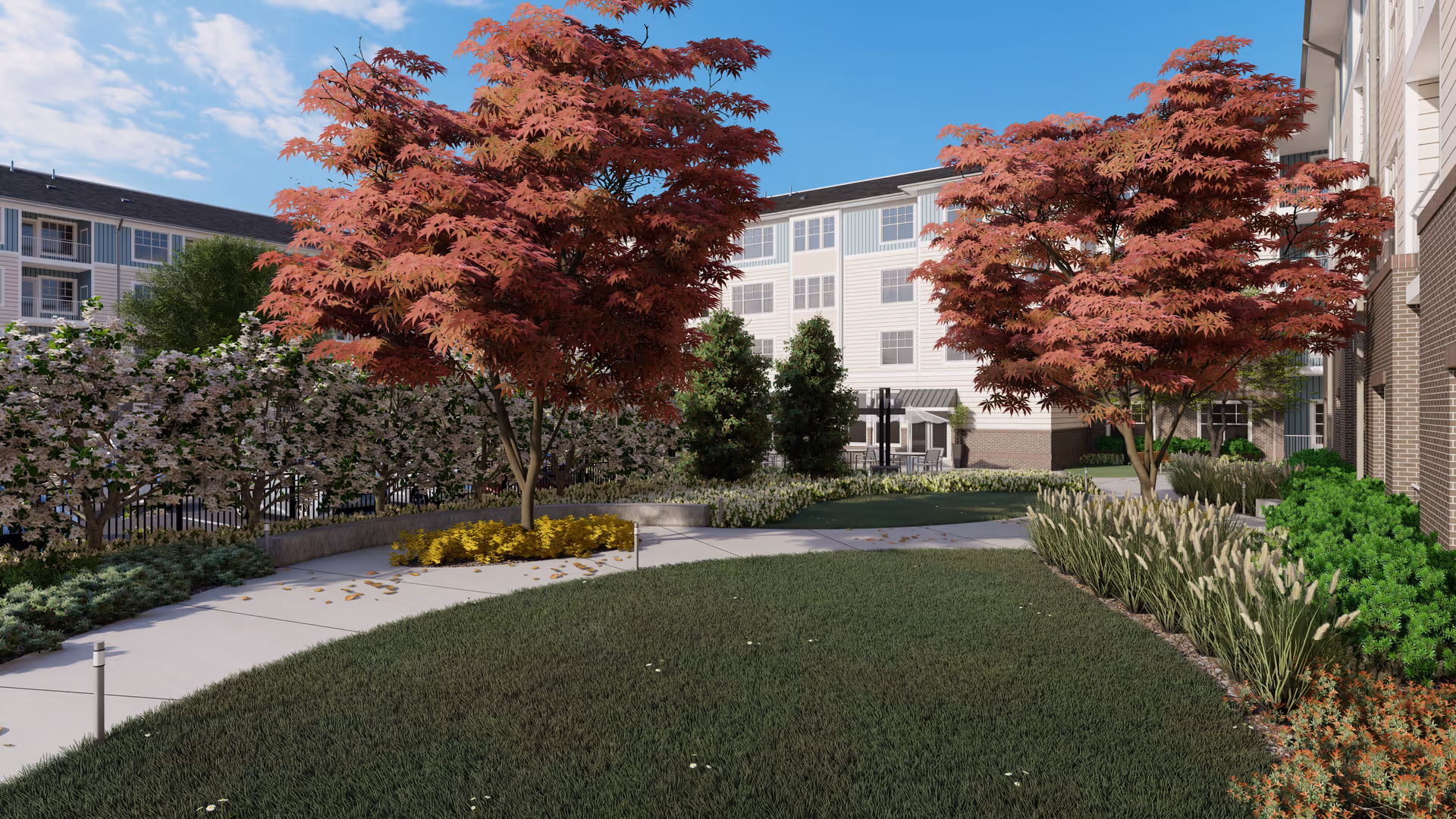 Outdoor garden area at Acclaim at Greenbrier featuring a curved concrete walkway, green grass, red-leafed trees, various shrubs, and a multi-story residential building in the background under a partly cloudy blue sky.