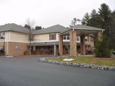Exterior view of a two-story senior living facility with a covered entrance.