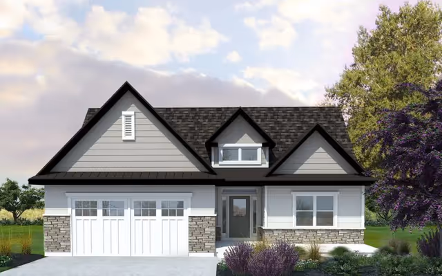 Front exterior view of a modern single-story house with a double garage, gray siding, stone accents, and a gabled roof, surrounded by greenery and trees under a partly cloudy sky.
