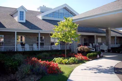 Exterior view of Pine Ridge of Garfield showing a covered entrance and landscaped grounds.