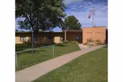 Exterior view of ANEW Healthcare and Rehab-Nortonville building with sidewalk.
